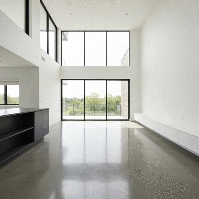 Modern living room with polished concrete flooring reflecting natural light